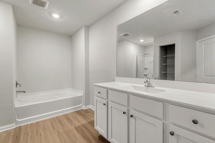 Luxurious primary bathroom with a soaking tub. Luxurious primary bathroom with a soaking tub.