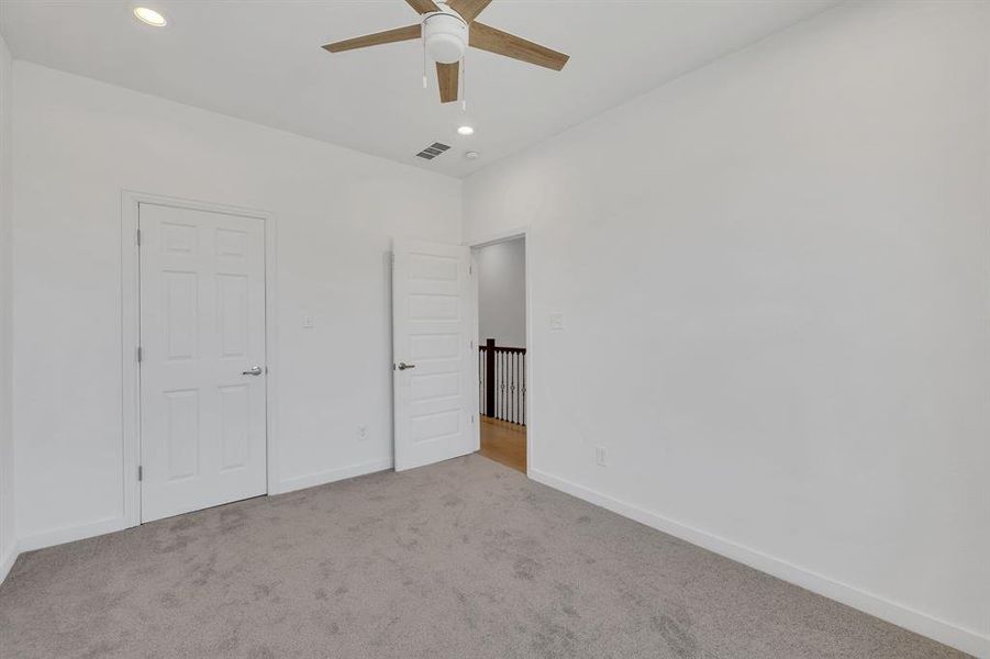 Unfurnished bedroom with light colored carpet, recessed lighting, and a ceiling fan