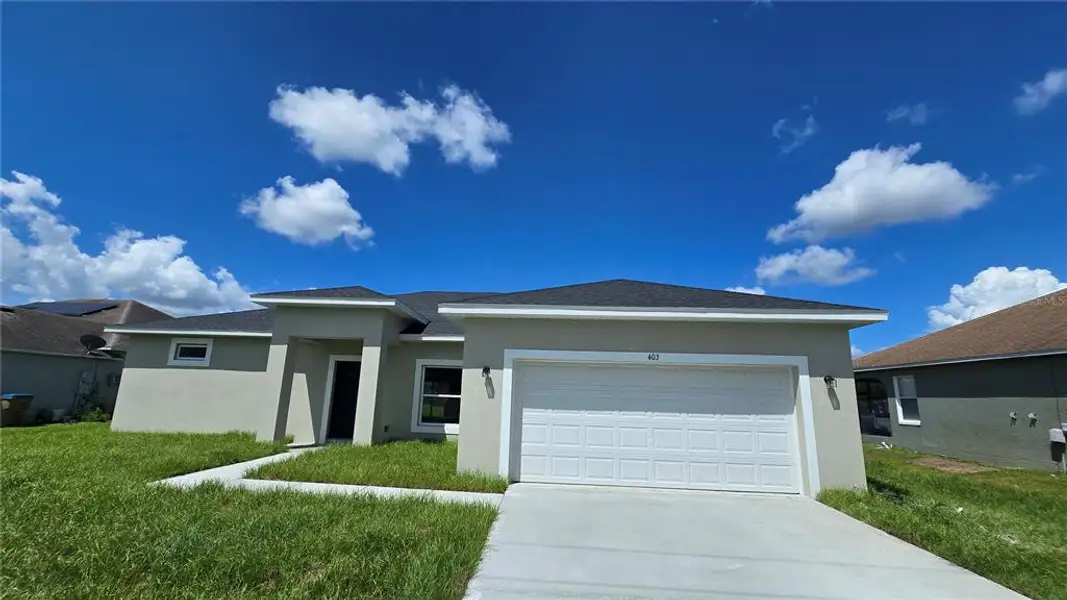 Front exterior of a new home in , Kissimmee, FL, highlighting curb appeal (Image 16).