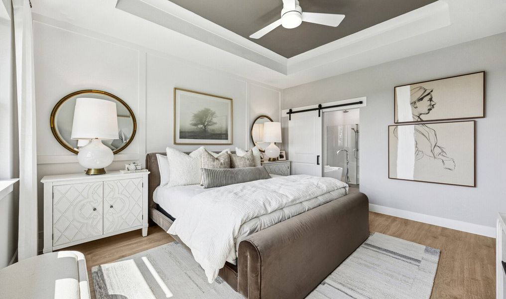 Primary suite with decorated feature wall & tray ceiling