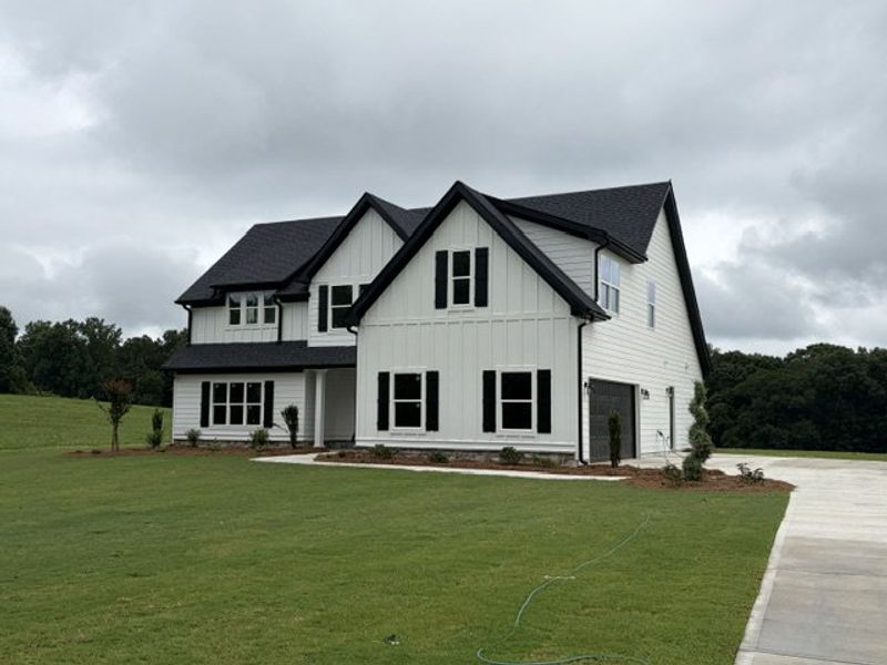 Front exterior of a new home in Blackwelder Bluff, Bowdon, GA, highlighting curb appeal (Image 2). Front exterior of a new home in Blackwelder Bluff, Bowdon, GA, highlighting curb appeal (Image 2).