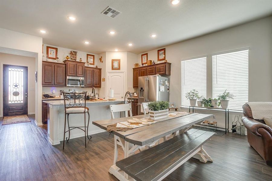 Dining space with dark wood-style flooring and recessed lighting Dining space with dark wood-style flooring and recessed lighting