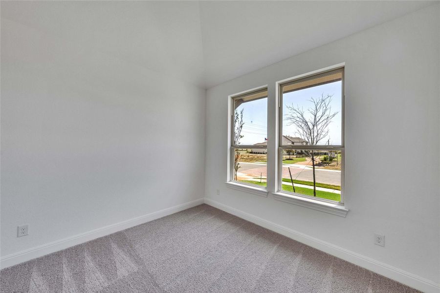 Spare room featuring baseboards and light colored carpet Spare room featuring baseboards and light colored carpet