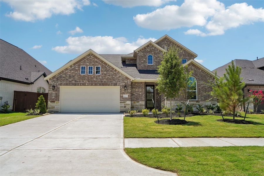 Front exterior of a new home in Evergreen 55', Conroe, TX, highlighting curb appeal (Image 1). Front exterior of a new home in Evergreen 55', Conroe, TX, highlighting curb appeal (Image 1).