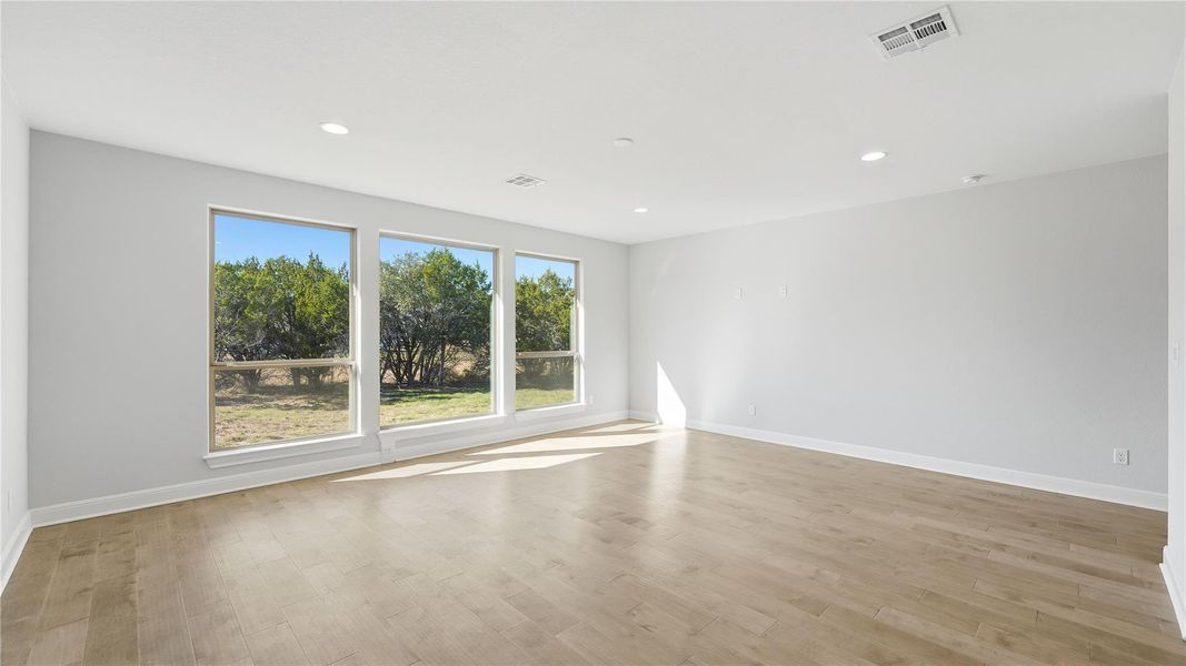 Unfurnished room featuring light wood-style flooring and recessed lighting Unfurnished room featuring light wood-style flooring and recessed lighting