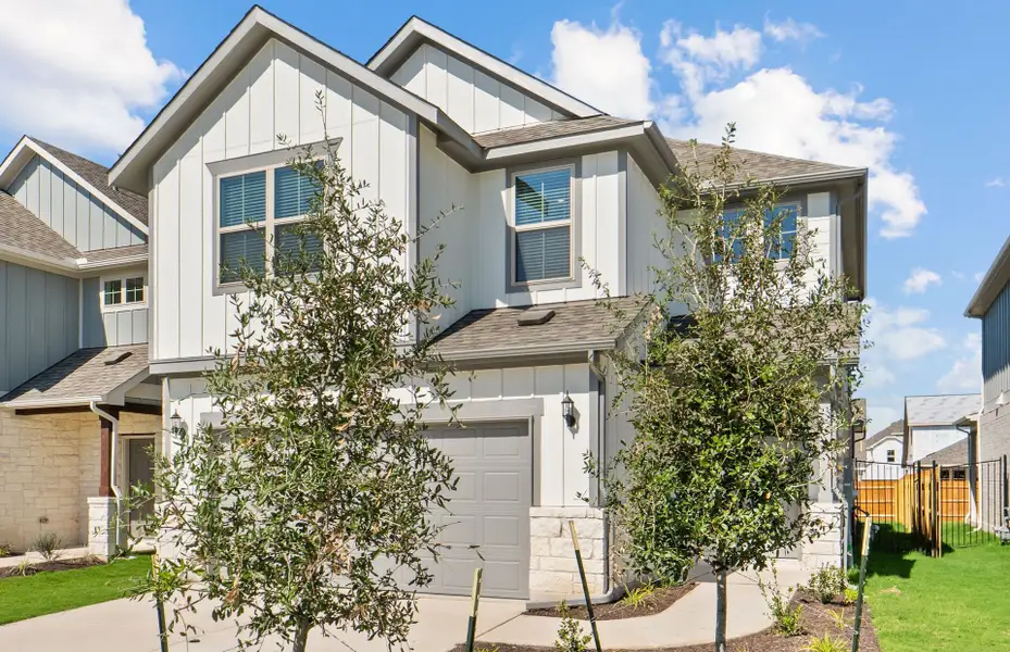 Front exterior of a new home in Santa Rita Ranch, Liberty Hill, TX, highlighting curb appeal (Image 2). Front exterior of a new home in Santa Rita Ranch, Liberty Hill, TX, highlighting curb appeal (Image 2).