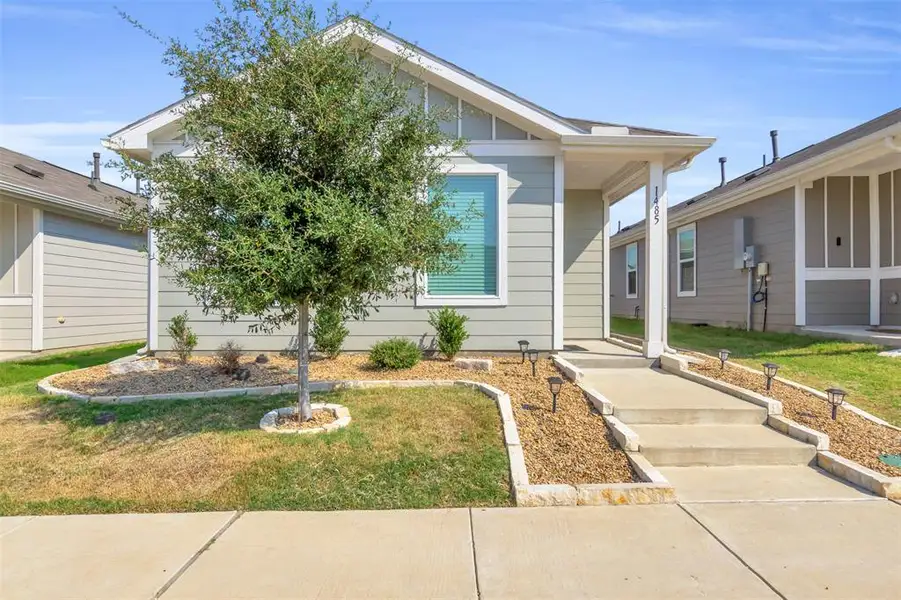View of front of home featuring board and batten siding and a front lawn