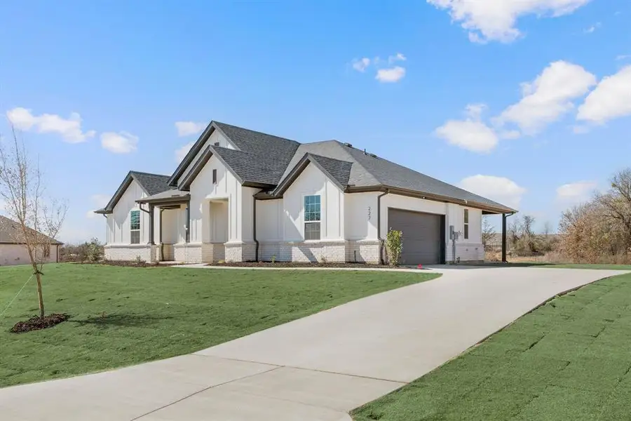 Front exterior of a new home in Saddleback Estates, Boyd, TX, highlighting curb appeal (Image 2). Front exterior of a new home in Saddleback Estates, Boyd, TX, highlighting curb appeal (Image 2).