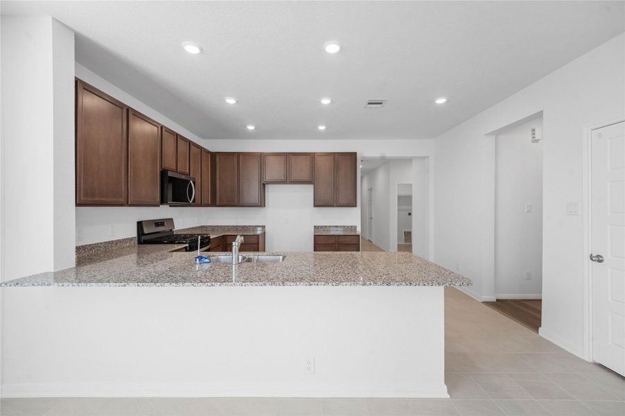 This spacious kitchen has it all—ample storage, generous counter space, and a layout that truly makes it the heart of the home.