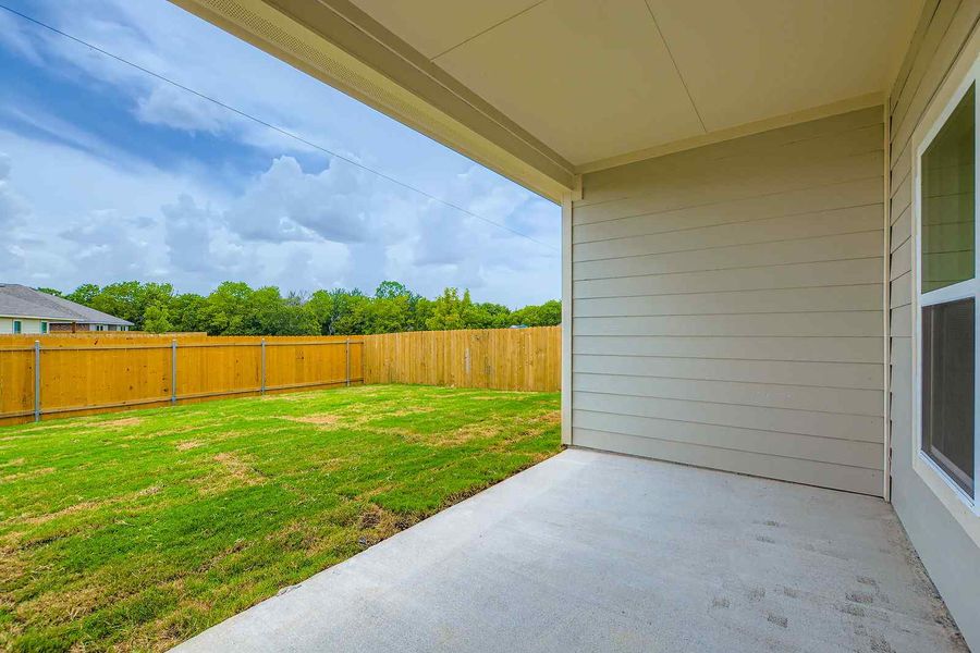 A house with a fence and grass.