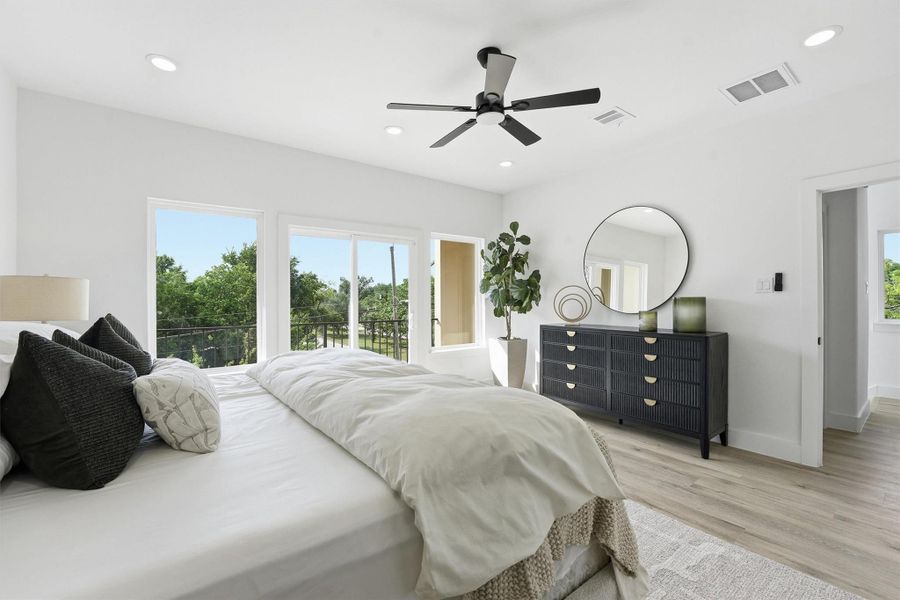 Incredible window space keeps the primary suite feeling light and bright.