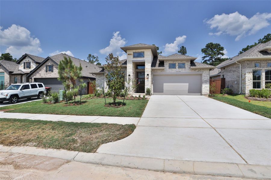 Front exterior of a new home in Evergreen, Conroe, TX, highlighting curb appeal (Image 2).