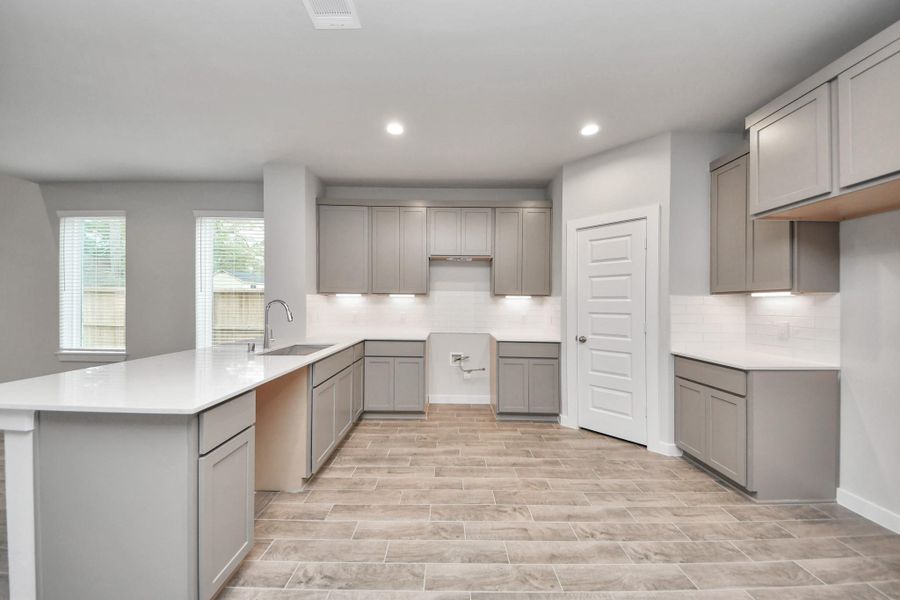 This generously spacious kitchen is a dream realized! Sample photo of completed home with similar floor plan. Actual colors and selections may vary.