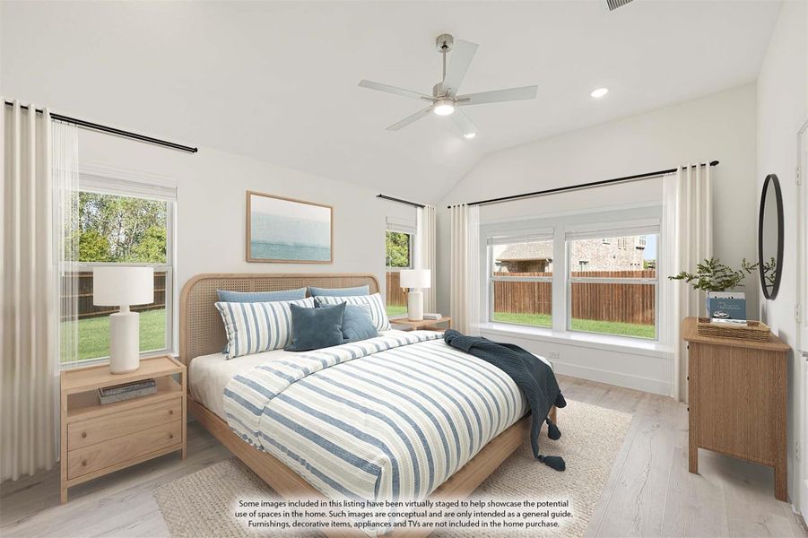 Bedroom with vaulted ceiling, ceiling fan, wood bed frame, and multiple windows with natural light