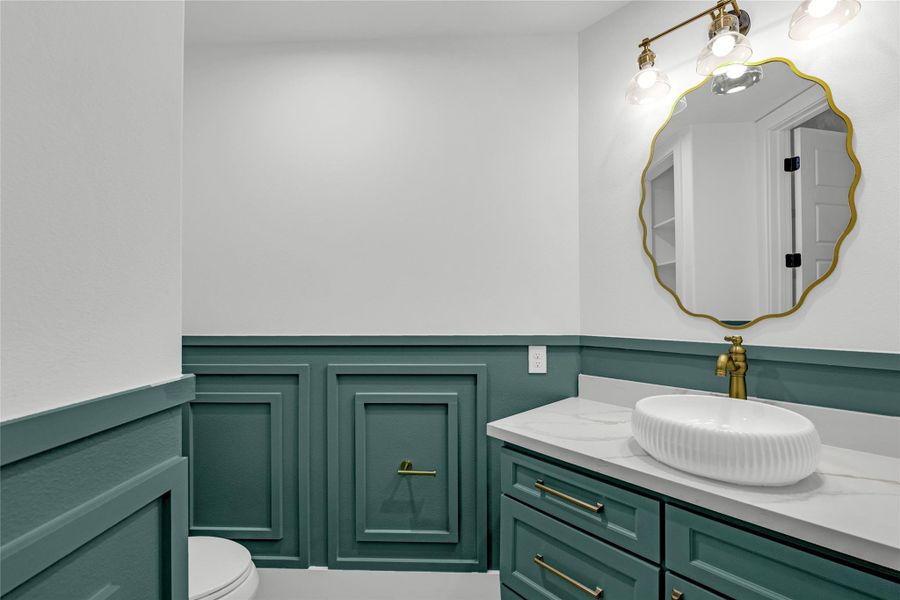 The downstairs half bath blends vintage style with practical design. This home has personality you won’t find in a cookie-cutter build. The downstairs half bath blends vintage style with practical design. This home has personality you won’t find in a cookie-cutter build.