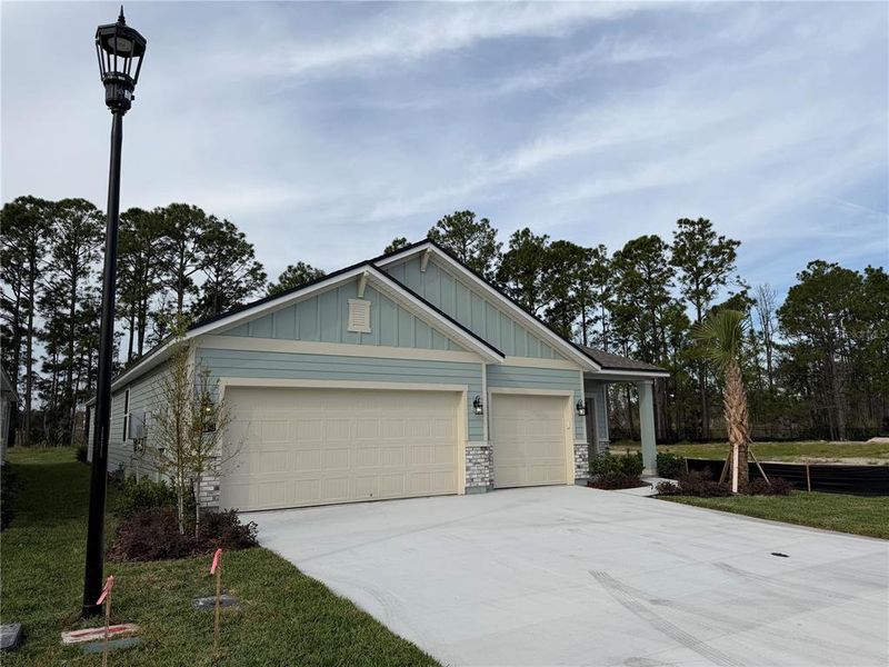 Front exterior of a new home in The Magnolia Series at Reserve East, Flagler Beach, FL, highlighting curb appeal (Image 20). Front exterior of a new home in The Magnolia Series at Reserve East, Flagler Beach, FL, highlighting curb appeal (Image 20).