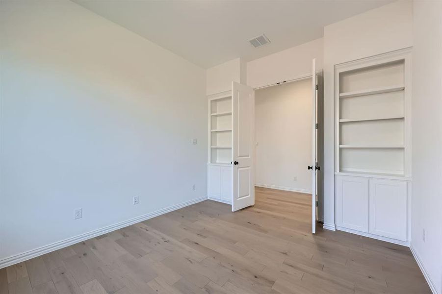 Unfurnished bedroom with light hardwood / wood-style flooring