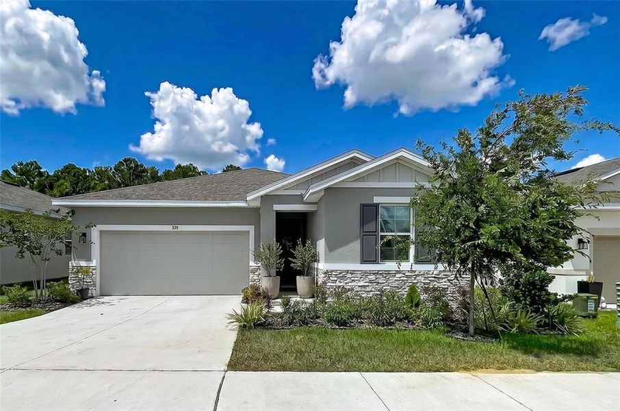 Front exterior of a new home in Seasons at Mabel Place, Lake Wales, FL, highlighting curb appeal (Image 30).
