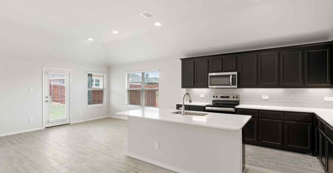 Representative exterior photo of a completed home built from the Atlanta by Impression Homes in Keeneland, Aubrey, TX (Image 6).