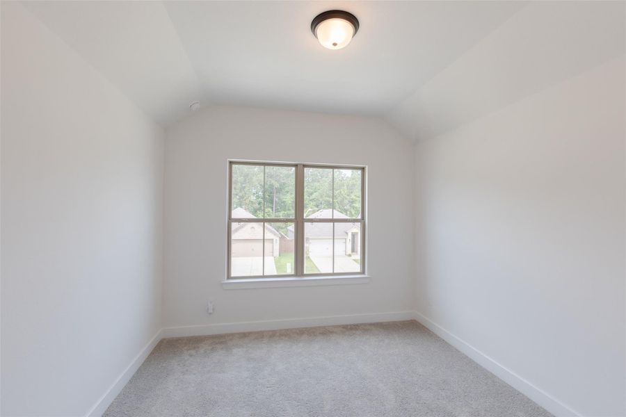 1st bedroom upstairs with neutral walls and carpeted floor