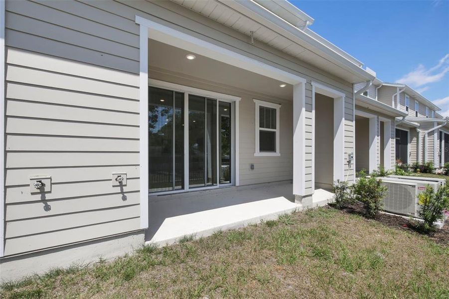 Exterior details and patio area of a home in Towns at Riverwalk, Sanford (Image 3).