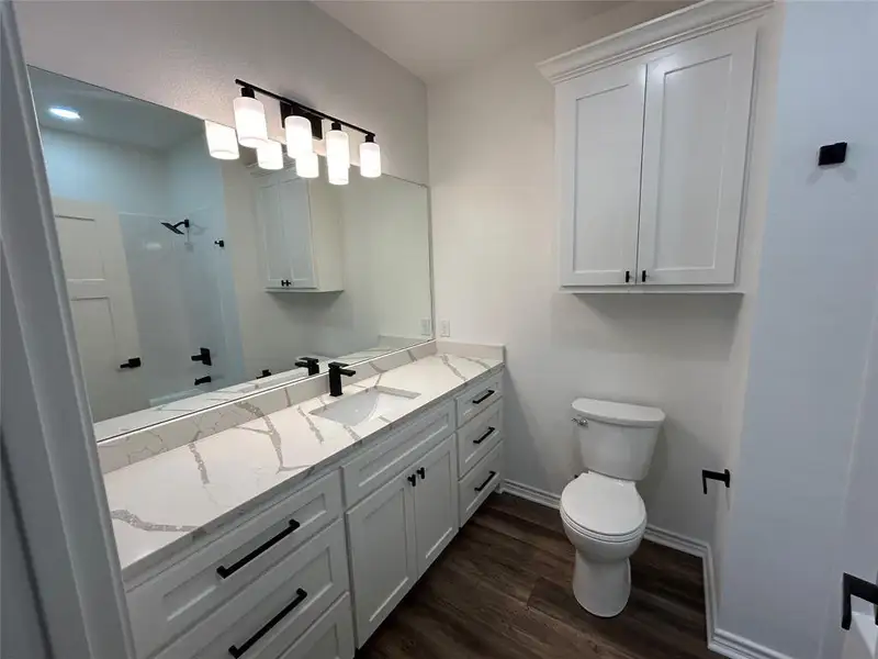Full bathroom with vanity, dark wood finished floors, and shower / bathtub combination