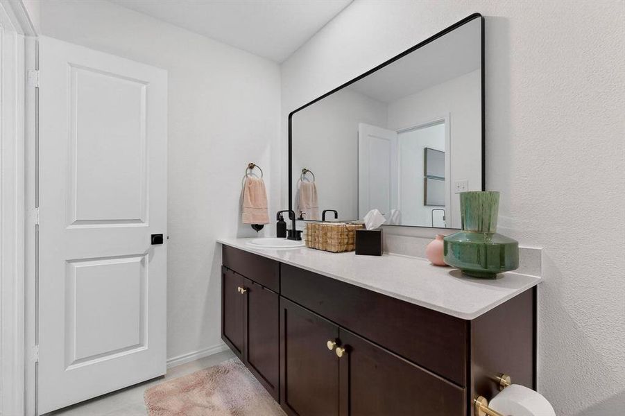 Bathroom with vanity and light tile patterned floors Bathroom with vanity and light tile patterned floors