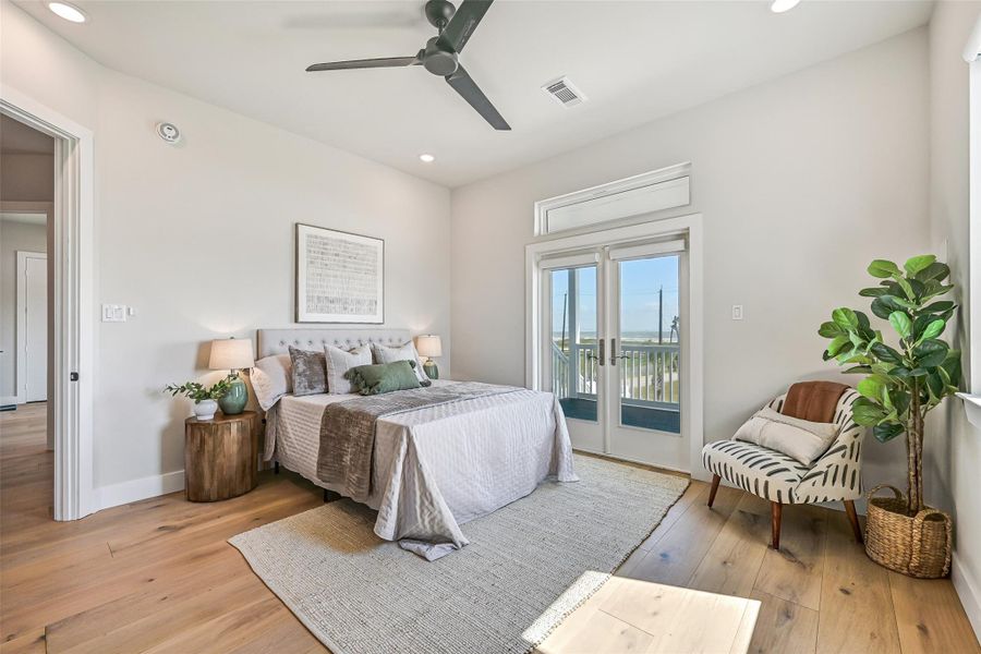 Wake up to Gulf breezes and glowing coastal light in this peaceful bedroom retreat with private porch access. Expansive windows create a relaxing connection to the outdoors and surrounding water views.