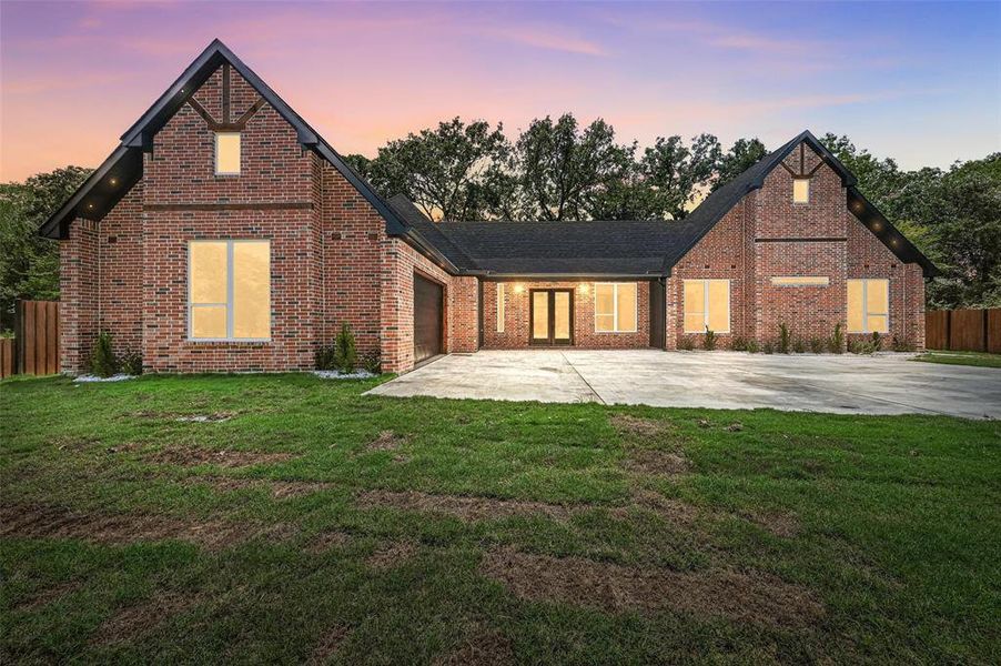 View of front of property with a garage, brick siding, and driveway View of front of property with a garage, brick siding, and driveway