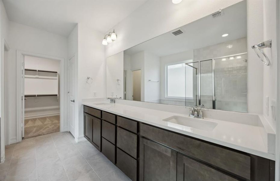 Spacious owner's suite with dual vanity  *real home pictured