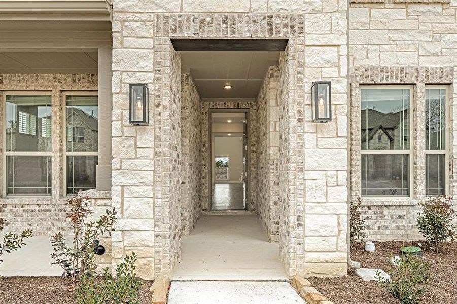 View of exterior entry with stone siding