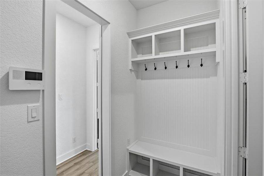 Mudroom featuring a textured wall and light wood-style flooring