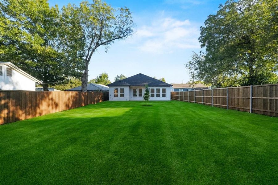 Back of property with a fenced backyard