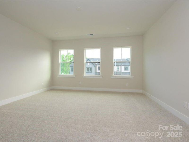 Primary Suite Highlighted by Bright and Warm Windows.