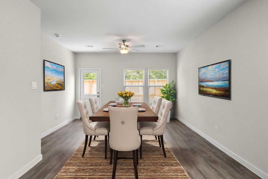 A dining room table with chairs.