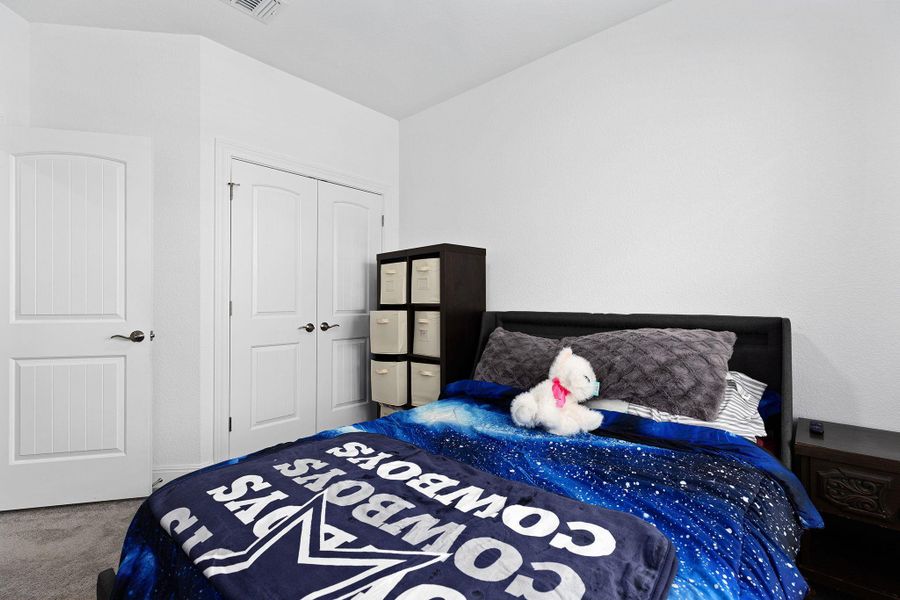 White paneled doors enhance the bright aesthetic of this cozy bedroom.