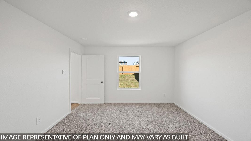 Empty room with light colored carpet and baseboards