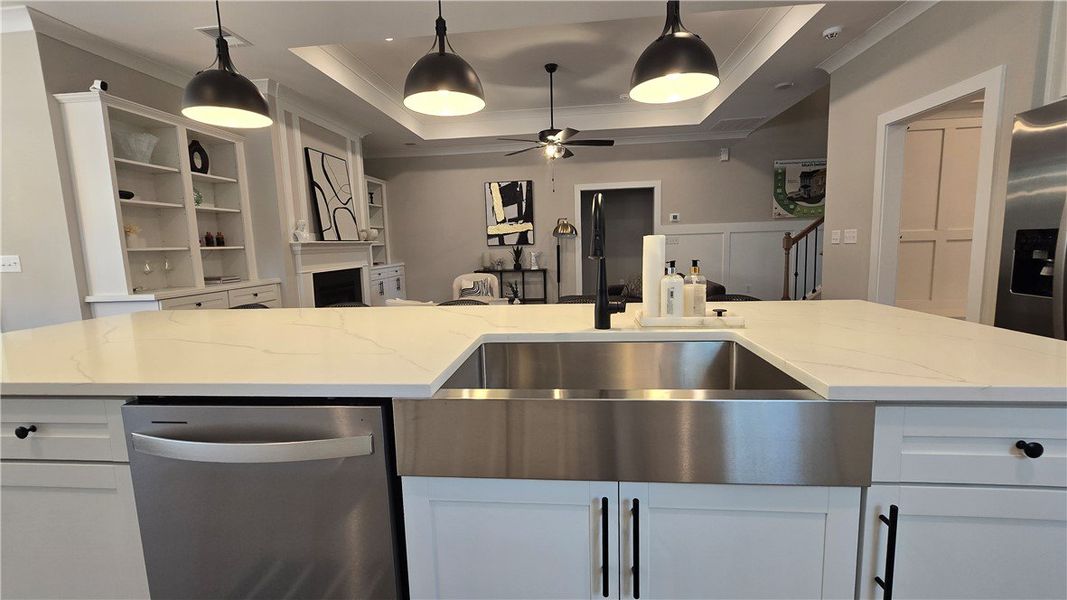A well-appointed kitchen island with gleaming stai A well-appointed kitchen island with gleaming stai