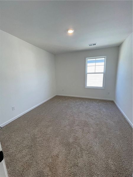 This cozy room offers soft carpeting and a window