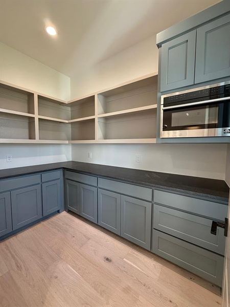Large Pantry, with custom cabinets, counter tops and built in microwave
