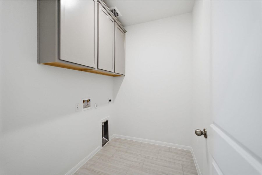 Laundry area featuring cabinet space, washer hookup, gas dryer hookup, and electric dryer hookup