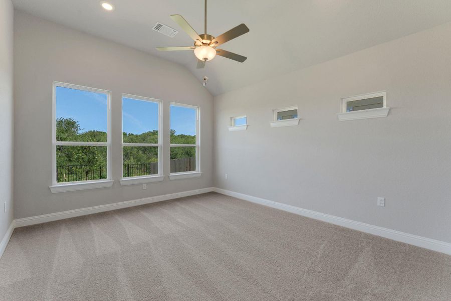 Empty room featuring a ceiling fan, vaulted ceiling, healthy amount of natural light, carpet floors, and recessed lighting Empty room featuring a ceiling fan, vaulted ceiling, healthy amount of natural light, carpet floors, and recessed lighting