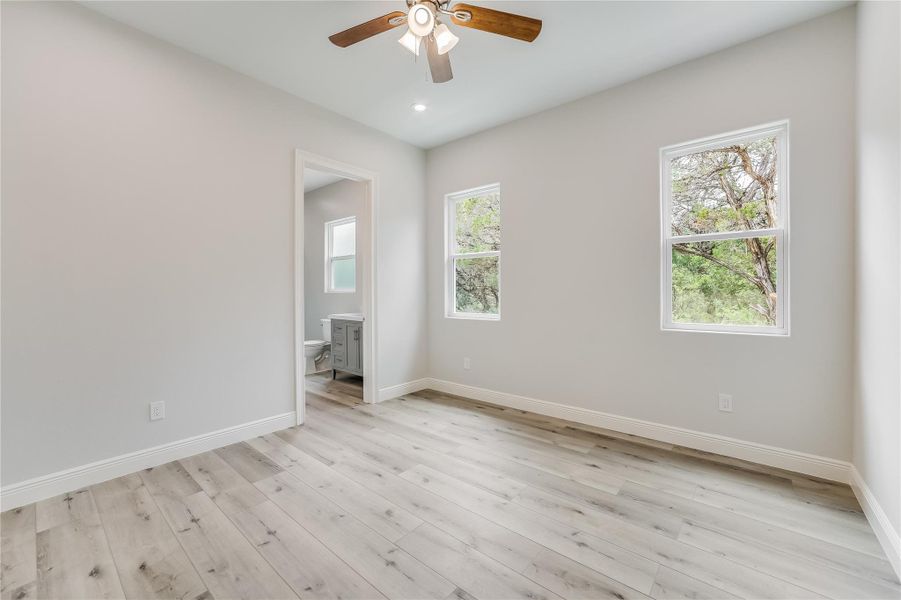 Empty room featuring ceiling fan and light hardwood / wood-style floors