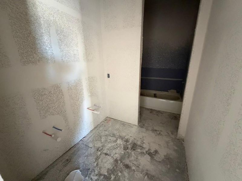 Bathroom with unfinished concrete flooring
