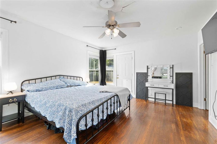 Bedroom featuring dark wood-type flooring and ceiling fan Bedroom featuring dark wood-type flooring and ceiling fan