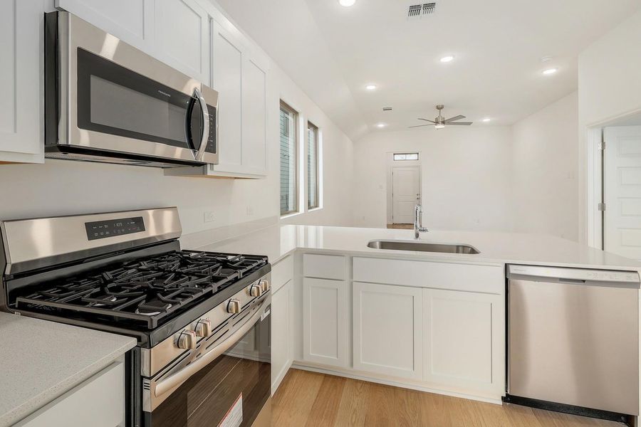 Kitchen in the Ash home plan by Trophy Signature Homes – REPRESENTATIVE PHOTO Kitchen in the Ash home plan by Trophy Signature Homes – REPRESENTATIVE PHOTO