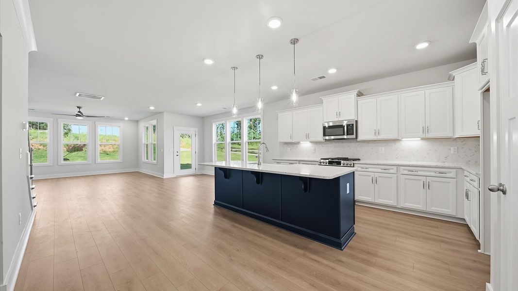 Highly skilled kitchen design includes a 9-foot island, quartz countertops, and stylish pendant fixtures in Anderson, SC