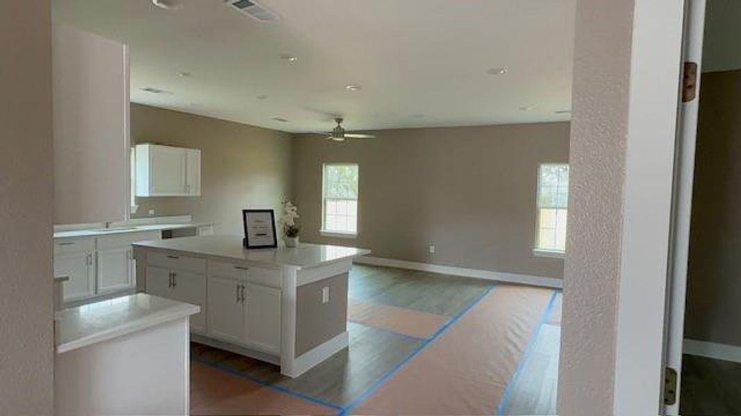 Kitchen with light countertops, white cabinets, and a center island