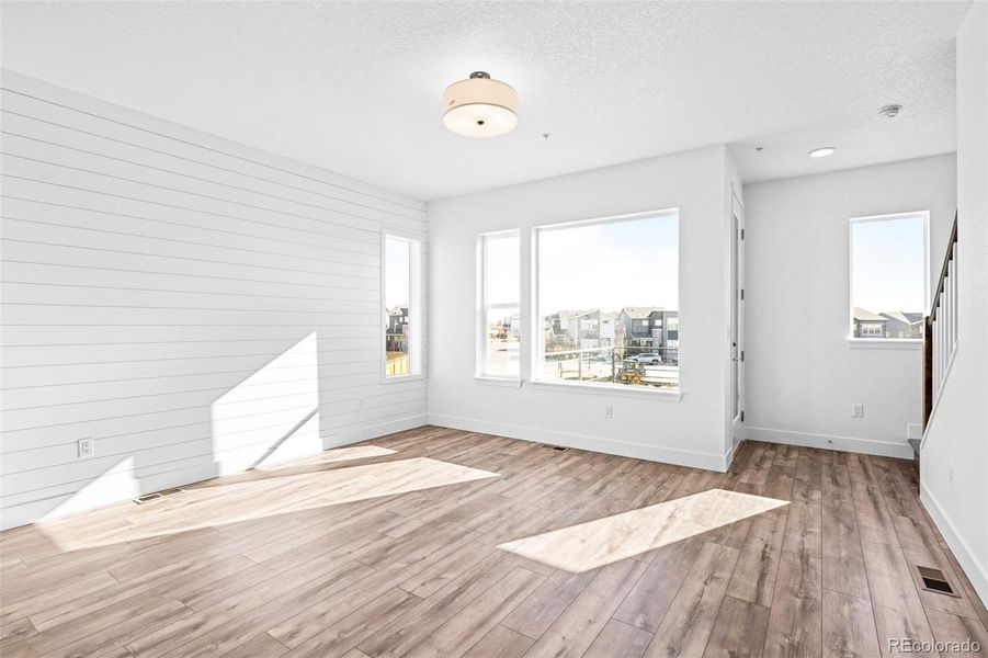 Living room with 9ft ceilings and large windows.
