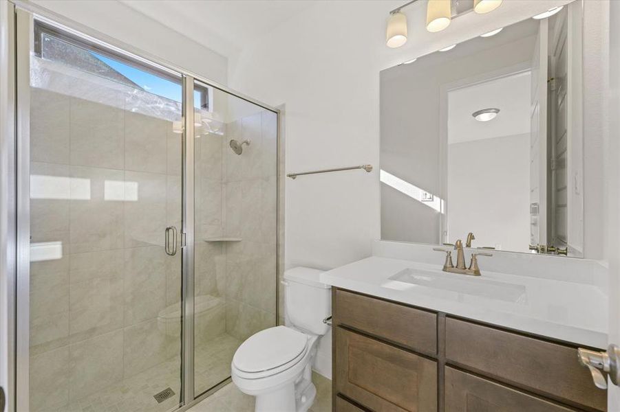 Full bath with a shower stall and vanity
